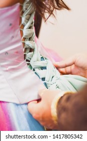 Hands Tying A Debutante Dress