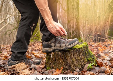 Hands Tying Shoelace On Hiking Shoes Before Walking. Tourist Getting Ready For Hiking. Sport Active Lifestyle Concept. 