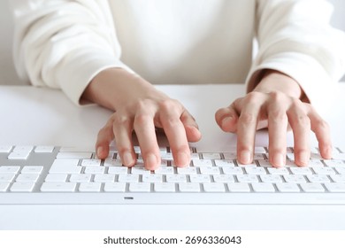 Hands typing characters using a keyboard