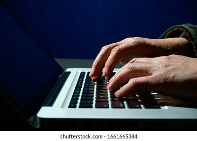 Hands typing in the dark      