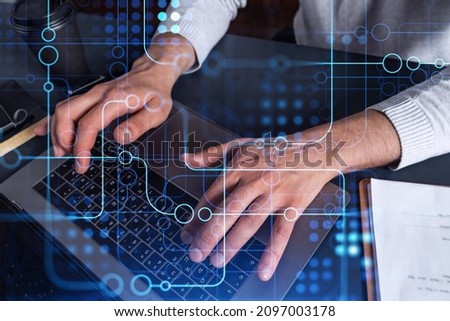 Hands typing the keyboard to create innovative software to change the world and provide a completely new service. Close up shot. Hologram tech graphs. Concept of Dev team.