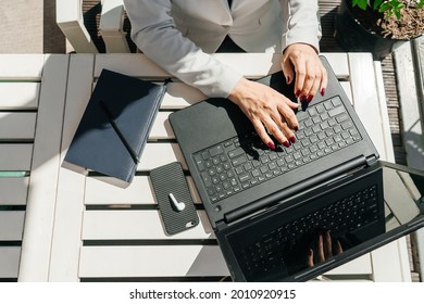 Hands typing in notebook. Window on background.