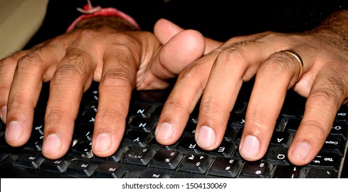 Hands Typing On A Black Keyboard