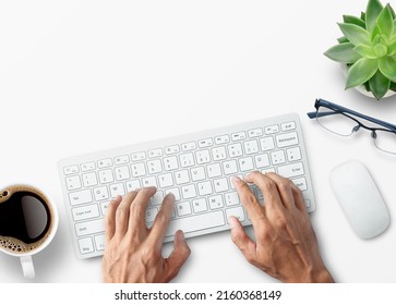 Hands typing on computer keyboard over white office desk table with cup of coffee and supplies. Top view with copy space, flat lay.