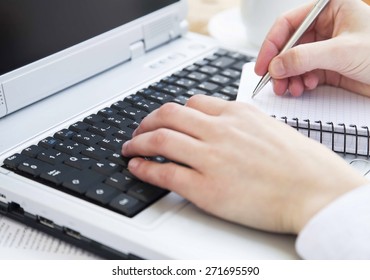 Hands Typing on Computer Keyboard and Taking Notes at Office.Office Business Worker Keyboarding