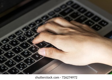 Hands typing on a computer keyboard, business online