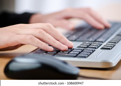 Hands Typing On The Keyboard