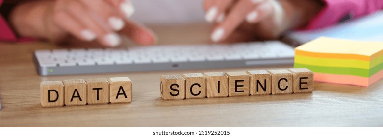 Hands typing on keyboard and data science text on cubes. Business marketing and Japanese research on Internet