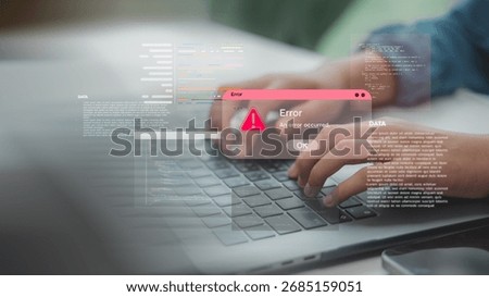 Hands typing on laptop with coding error alert popup, representing software bugs, programming issues, or system failure in development process and debugging in tech environments.
