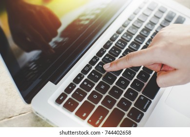 Hands typing on laptop computer.