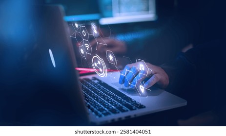 Hands typing on a laptop with digital icons overlay. Technology and innovation concept. Blue-toned tech background with digital interface elements. Hacker or software developer working on system.
