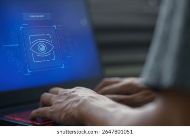 Hands typing on a laptop display a cyber security concept with an eye icon, symbolizing the importance of data protection in technology and network safety.