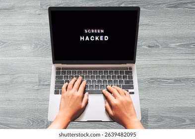 Hands Typing on Laptop Displaying Glitched “SCREEN HACKED” Alert