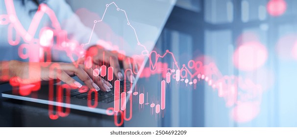 Hands typing on a laptop with a financial graph overlay, in an office setting. Concept of financial analysis and market trends - Powered by Shutterstock