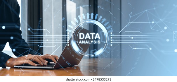 Hands typing on a laptop with a futuristic digital data analysis interface overlay on a blurred office background, representing data analysis and technology