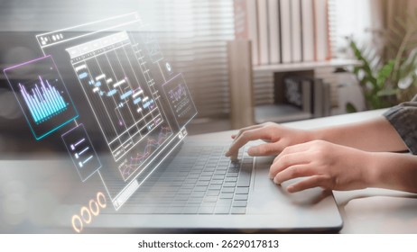 Hands typing on a laptop with a futuristic digital dashboard interface, showing data analytics, charts, and project management tools in a modern workspace.
