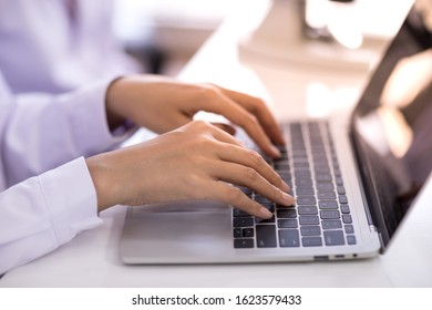 Hands typing on laptop keyboard - Shutterstock ID 1623579433