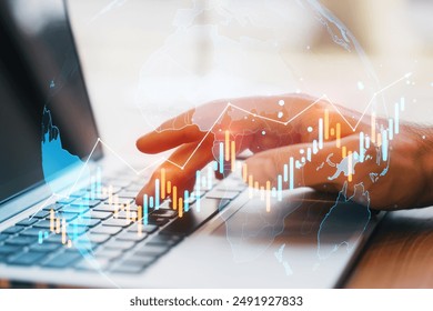 Hands typing on a laptop keyboard with a transparent overlay of financial charts and world map. On a light background, concept of global business and market analysis