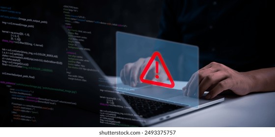 Hands typing on a laptop keyboard with a red warning symbol displayed on a virtual interface, indicating a cybersecurity threat or system error code