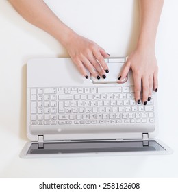 Hands Typing On Laptop Keyboard At Office Table, Top View.