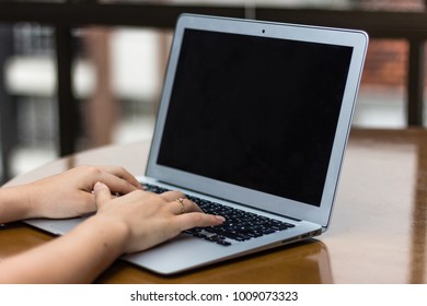Hands typing on a laptop. Woman working on a computer. Black screen. - Shutterstock ID 1009073323
