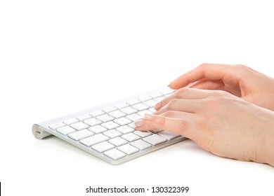 Hands typing on the remote wireless computer keyboard in an office at a workplace isolated on a white background