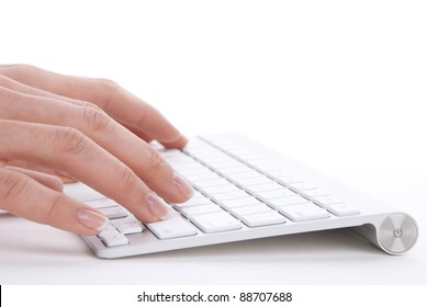 Hands Typing On The Remote Wireless Computer Keyboard In An Office At A Workplace Isolated On A White Background