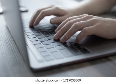 Hands Typing On Silver Laptop Computer Keyboard, Close Up