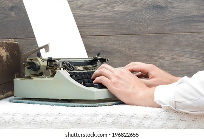 Hands typing on a typewriter