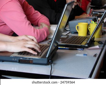 hands typing on a white computer keyboard