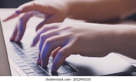 hands typing a program on a computer keyboard
