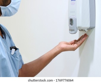 Hands Under An Automatic Hand Sanitizer Machine/soap Dispenser. Infection Control Concept. Hand Hygiene Has Very Essential Role In Prevention Of Infective Diseases.