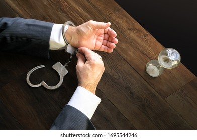 Hands unfasten the handcuffs. Open handcuffs on the male hands of the arrested person. Acquittal of an innocent defendant , a businessman in a black suit. Termination of criminal prosecution.         