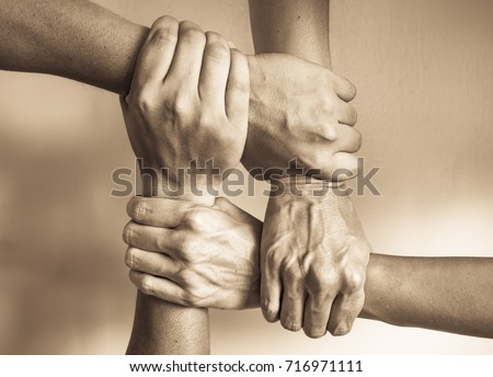 Hands united helping each other. In unity there is strength concept. 
