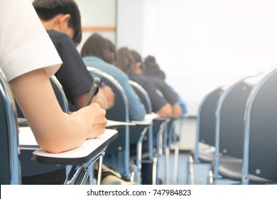 Hands University Student Holding Pen Writing /calculator Doing Examination / Study Or Quiz, Test From Teacher Or In Large Lecture Room, Students In Uniform Attending Exam Classroom Educational School.