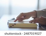 Hands of a university student reading a dictionary