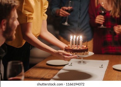 Hands Of Unrecognisable Woman Putting Birthday Cake On The Table.