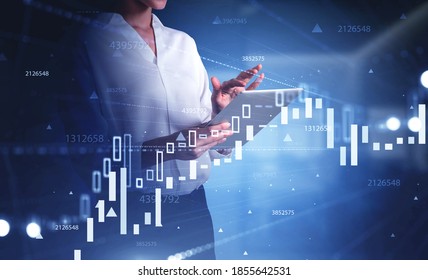 Hands of unrecognizable businesswoman using tablet in blurry office with double exposure of graphs. Toned image - Shutterstock ID 1855642531