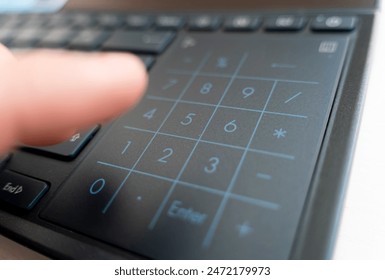 hands using a computer. fingers typing a laptop. Laptop keyboard being used by hands. the finger presses the numbers on the keyboard. Electronic numpad on a black laptop. - Powered by Shutterstock - Get 15% off with code: PIKWIZARD15