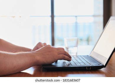 Man´s hands using a computer. Working online as a freelance.