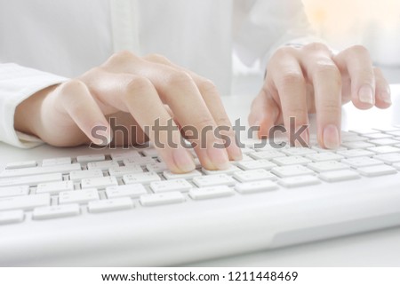 Hands are using the keyboard.