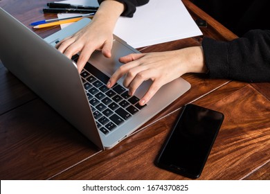 hands using the keyboard of a laptop