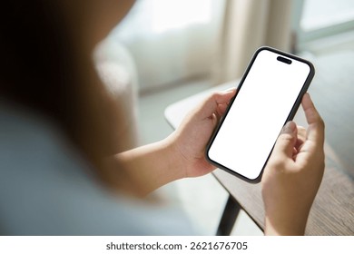 Hands using a mobile phone with empty display ready for design, app interface showcase, or digital product preview.