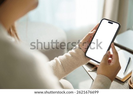 Hands using a mobile phone with empty display ready for design, app interface showcase, or digital product preview.