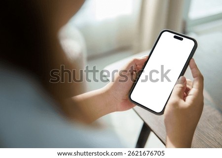 Hands using a mobile phone with empty display ready for design, app interface showcase, or digital product preview.