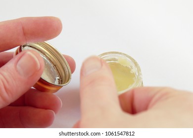 Hands Using Rich Oil Or Chrism From A Crucible, On White Background