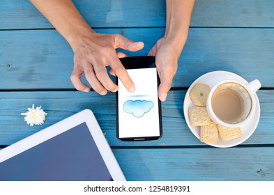 Hands Using Smart Phone With Cloud Technology On Screen.Safe Data Provider And Technical Support.Hybrid Cloud Platform Concept.Flat Lay Background 