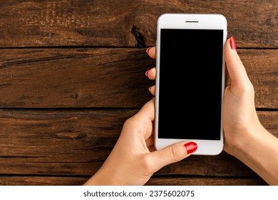 Woman’s hands using smart phone with empty screen