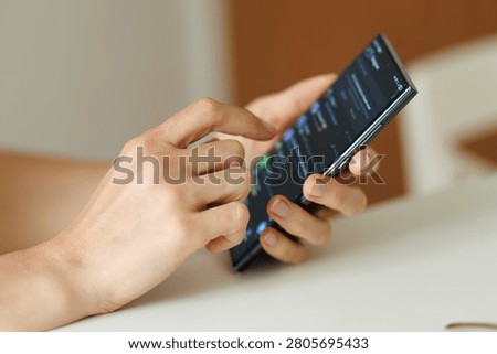 Hands using a smartphone to check notifications browse mobile apps read messages and manage daily digital activities. Close up with copy space.