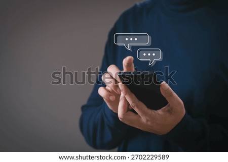 Hands using a smartphone with digital chat bubbles, symbolizing messaging, online communication, social interaction, mobile chatting, customer support, and modern digital connection.